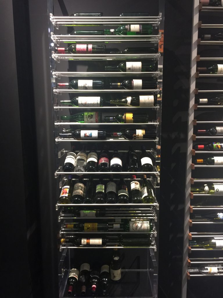 Modern wine shelves that pull out in this temperature controlled wine room.