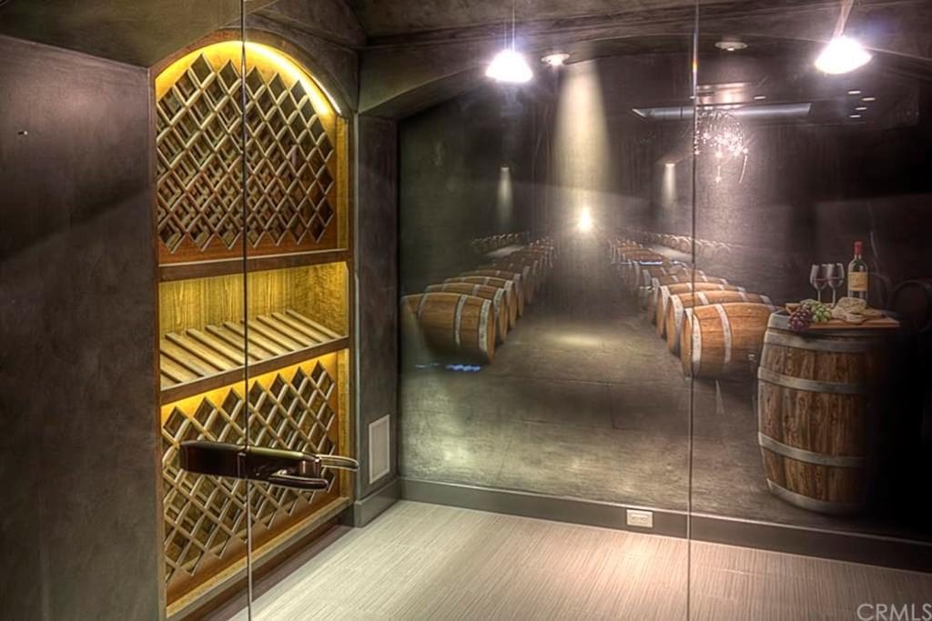 A painted mural in this wine room adds a decorative element and a 3D effect of being part of a larger cellar. 