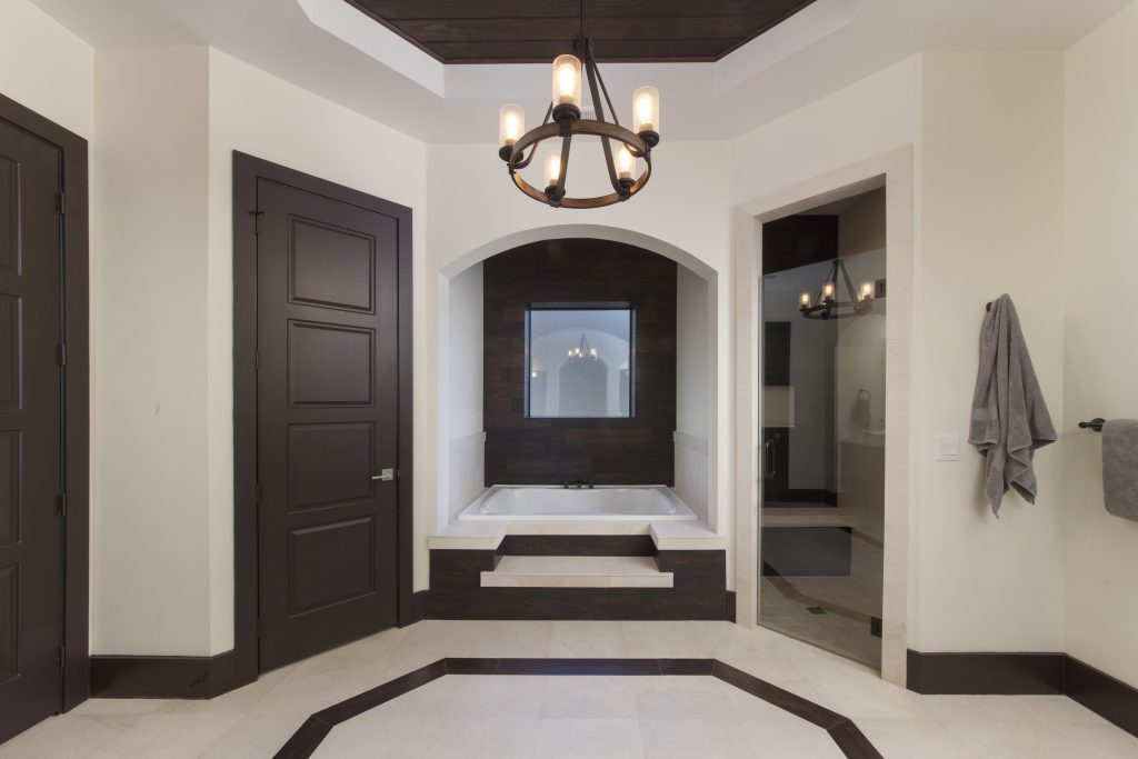 Master Bathroom in Villa Sirena, a home by Orlando Custom Home Builder Jorge Ulibarri mixes wood-looking tile with natural wood ceilings, white quartz counters and espresso wood cabinets for a warm contemporary look.