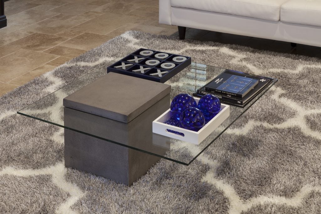 Texture, gray, white and blue color pallette and concrete, glass and metallics interplay to give the space a contemporary vibe that is serene and warm. Decor by Karen LeBlanc in Villa Sirena, a home by Orlando Custom Home Builder Jorge Ulibarri.