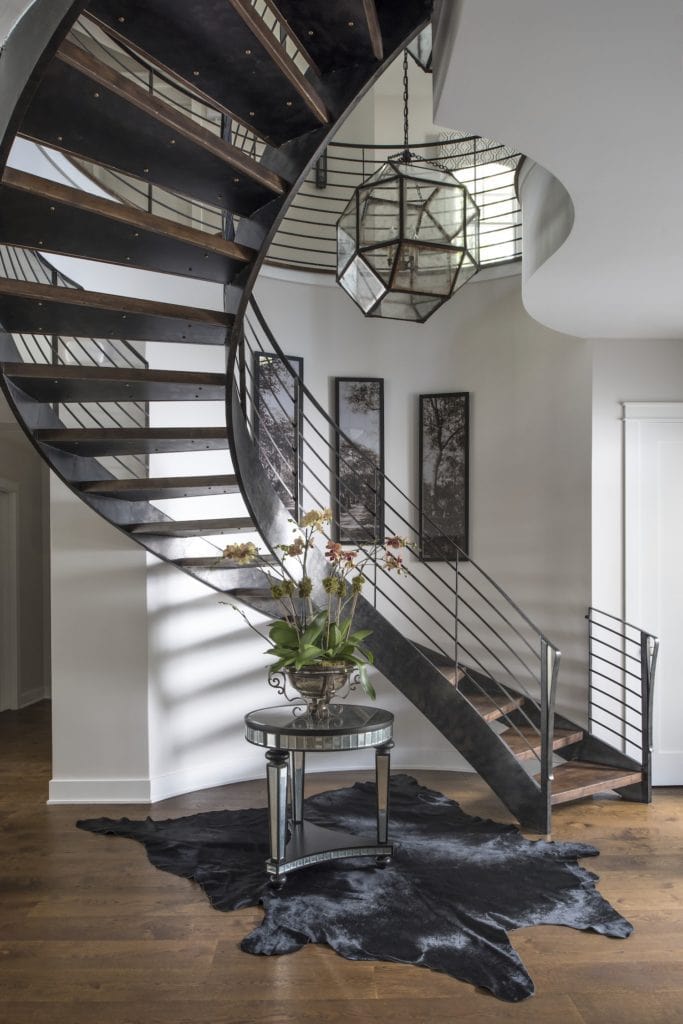 This floating staircase curves to stylishly accommodate a narrow space in the foyer. For more design ideas by Orlando Custom Home Builder go to www.jorgeulibarri1.wpengine.com