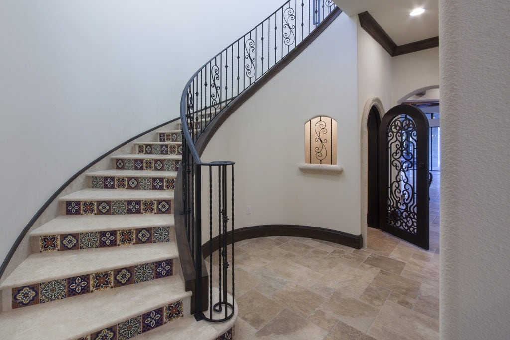 Orlando Custom Home Builder Jorge Ulibarri designed and built this staircase in a Lake Nona home with a walk-in wine storage room. For more design ideas by Orlando Custom Home Builder go to www.jorgeulibarri1.wpengine.com