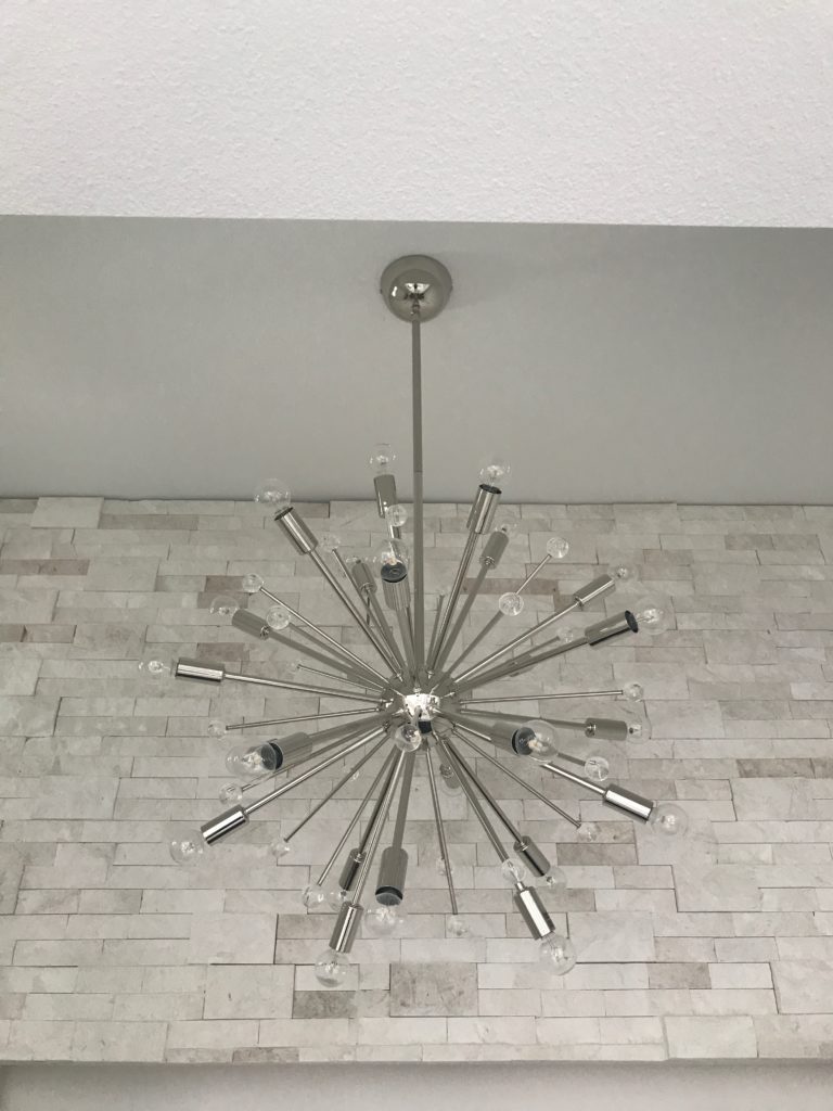 Starburst light fixture in the wine room of this Florida Modern home in Lake Mary designed and under construction by Orlando Custom Home Builder Jorge Ulibarri. www.imyourbuilder.com 
