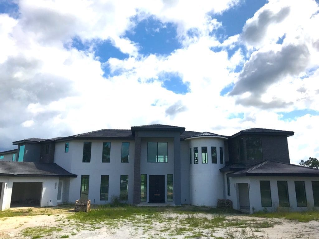Florida Modern styled home under construction by Orlando Custom Home Builder Jorge Ulibarri spans 10,000 square feet and wraps around a ski and boating lake in Lake Markham Preserve. www.imyourbuilder.com