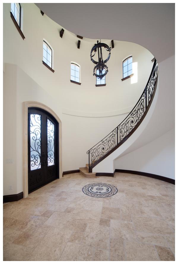 VIlla Hernandez makes a grand entrance with its Stone Tower that opens to a winding staircase and two-story ceiling that soars. Orlando Custom Home Builder Jorge Ulibarri designed and built the home for a client who wanted a Mediterranean inspired custom residence. For more, go to www.imyourbuilder.com